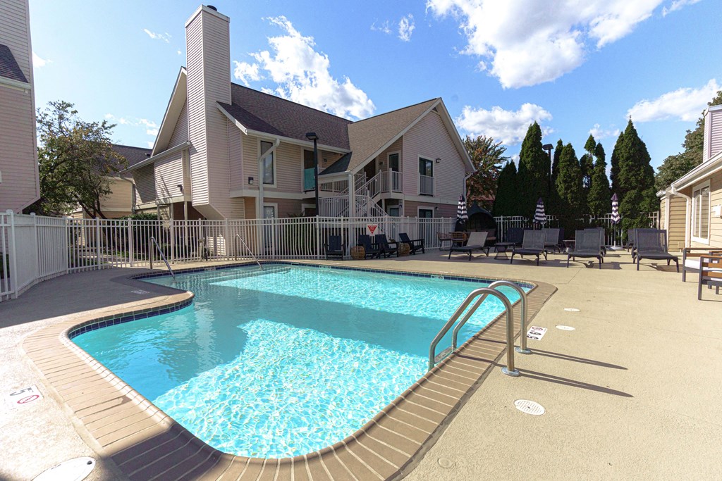 a pool with a house in the background